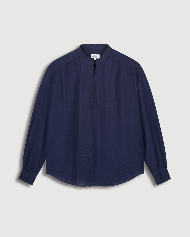 Navy blue shirt on a light gray background